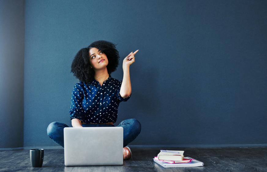 woman pointing up with laptop 