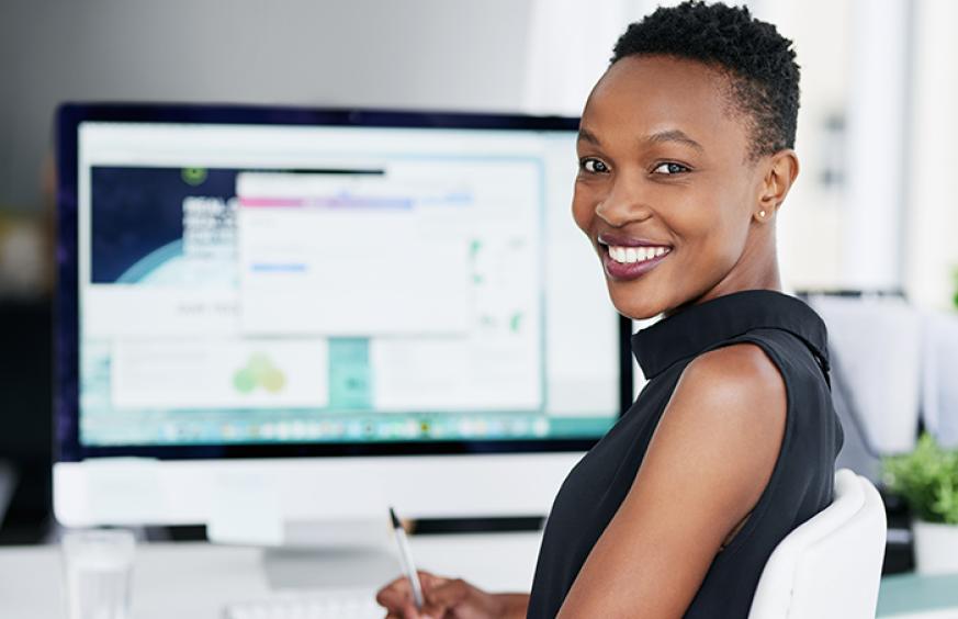 Female smiling at computer