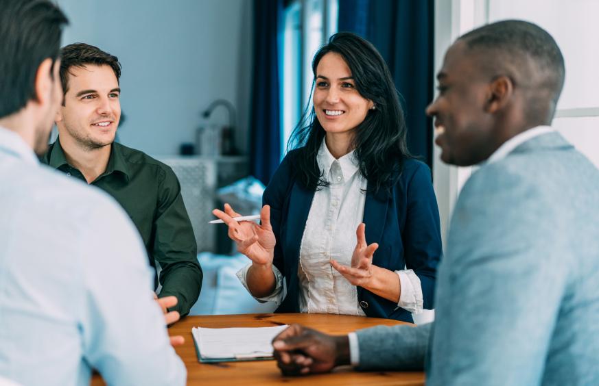 ALCS Business talking in group at office table