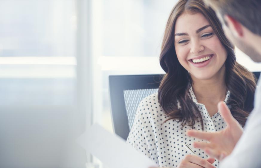 Happy woman looking at paperwork meeting